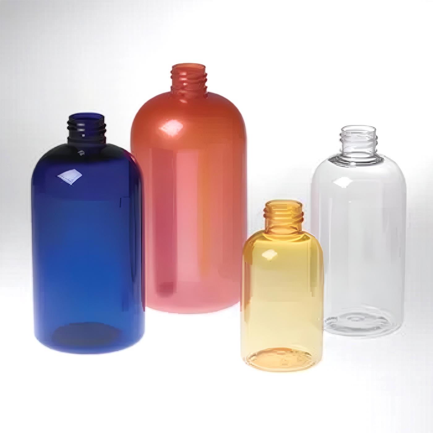 four shorter or squattier boston round bottles in cobalt blue, red, yellow, and clear, shown in multiple sizes