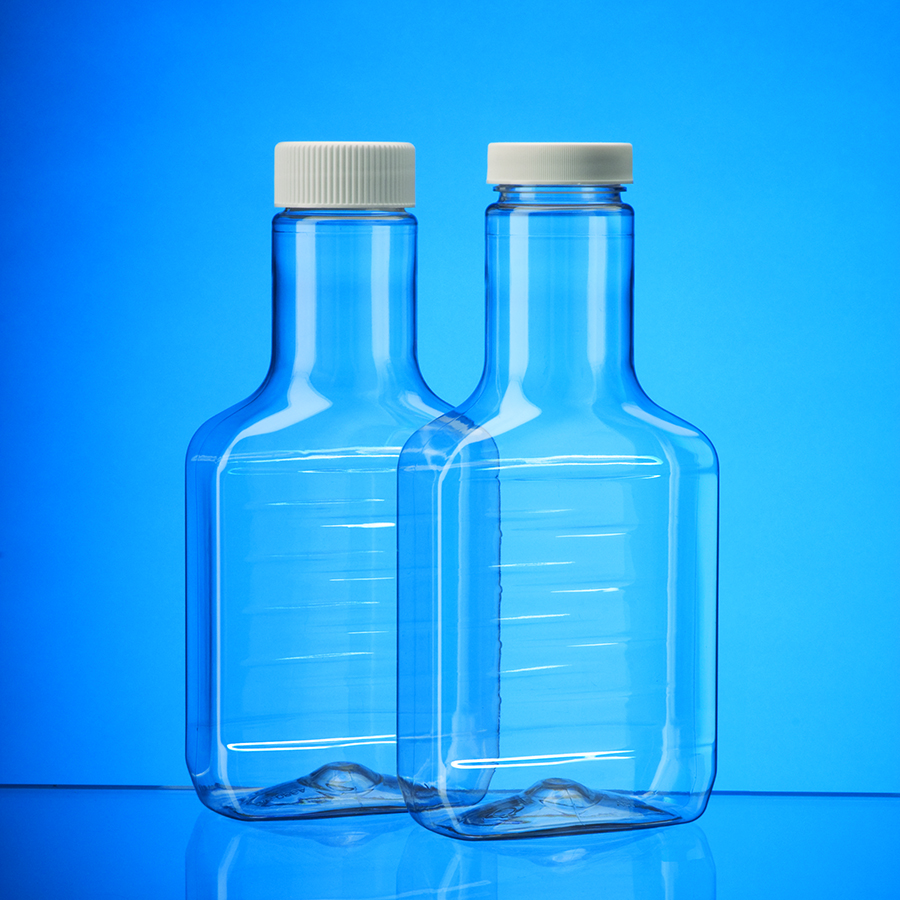 2 oblong clear plastic bottles with flat front and back panels and tall necks