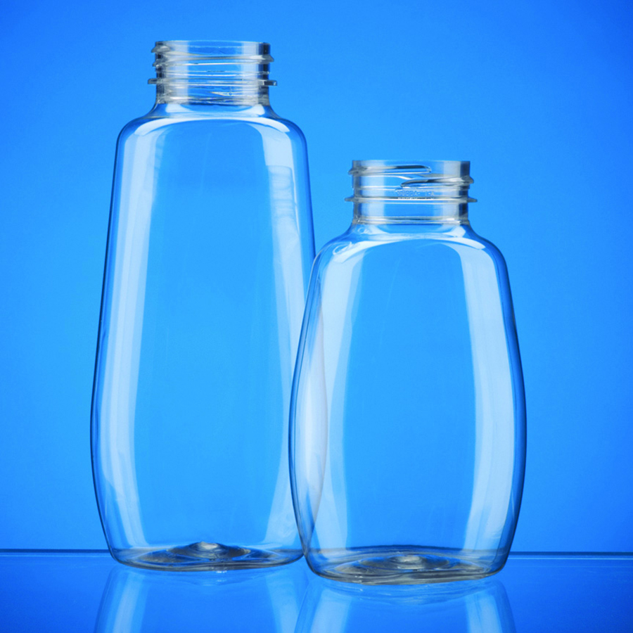 two clear plastic oblong or oval bottles wider at the bottom.