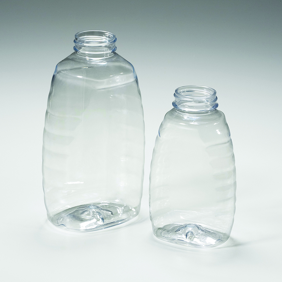 two clear plastic oval bottles with contoured shape, large front panel area for label, ribbed sides