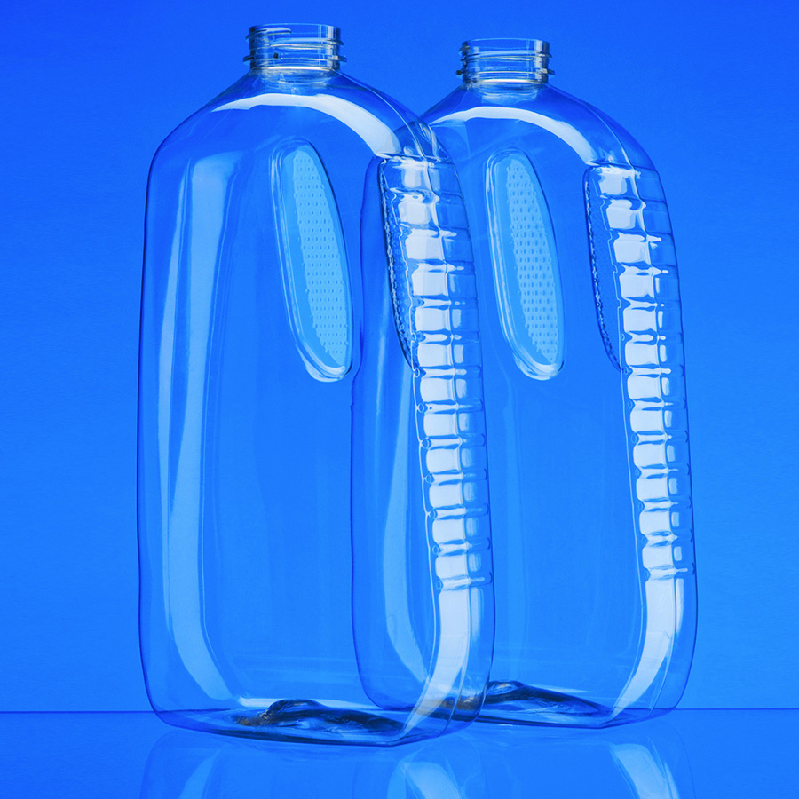2 large clear plastic oblong bottles with indents and ribbed sides for gripping.