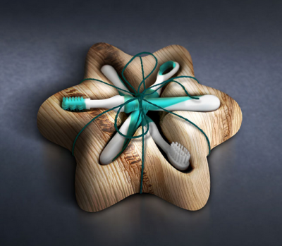 Flower Design A flower-shaped wooden holder made from layered natural wood contains five toothbrushes arranged like petals. The toothbrushes are white with teal accents and are tied together at the center with green string. The wood grain and layered edges are clearly visible, giving the product a handmade, organic appearance.